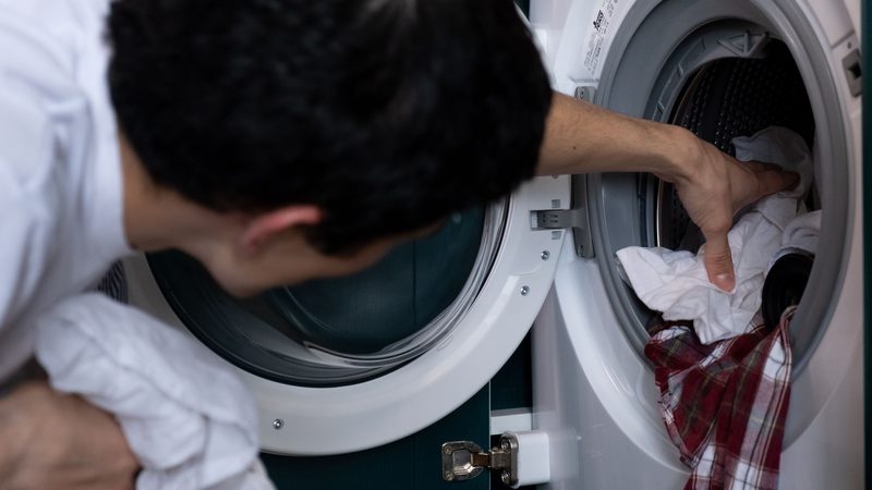 Tools laid out beside an opened washing machine