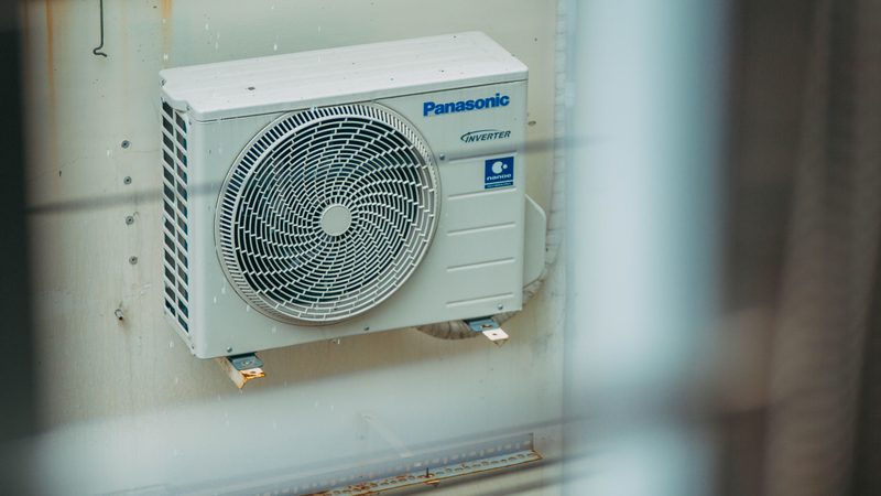 A living room with a wall-mounted air conditioning unit