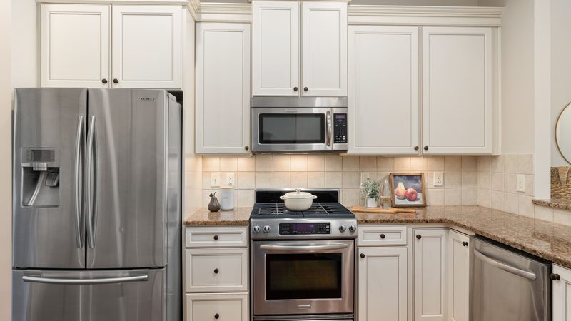 A stainless steel refrigerator in a fitted kitchen